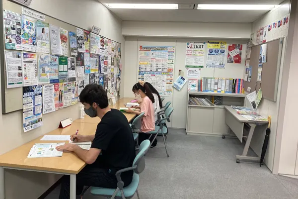 three students studying on individual desks